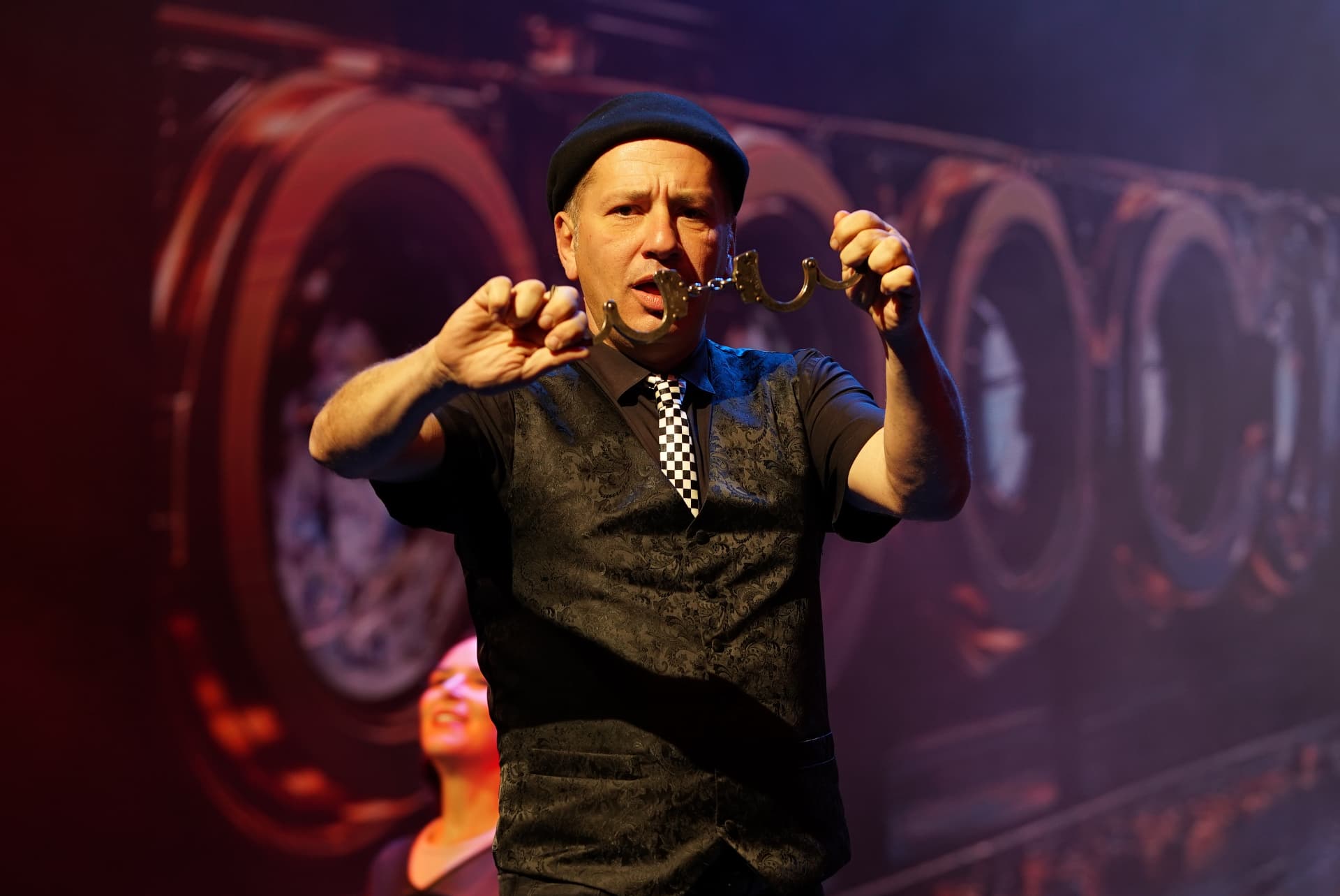 Magician in black with handcuffs — theatre show