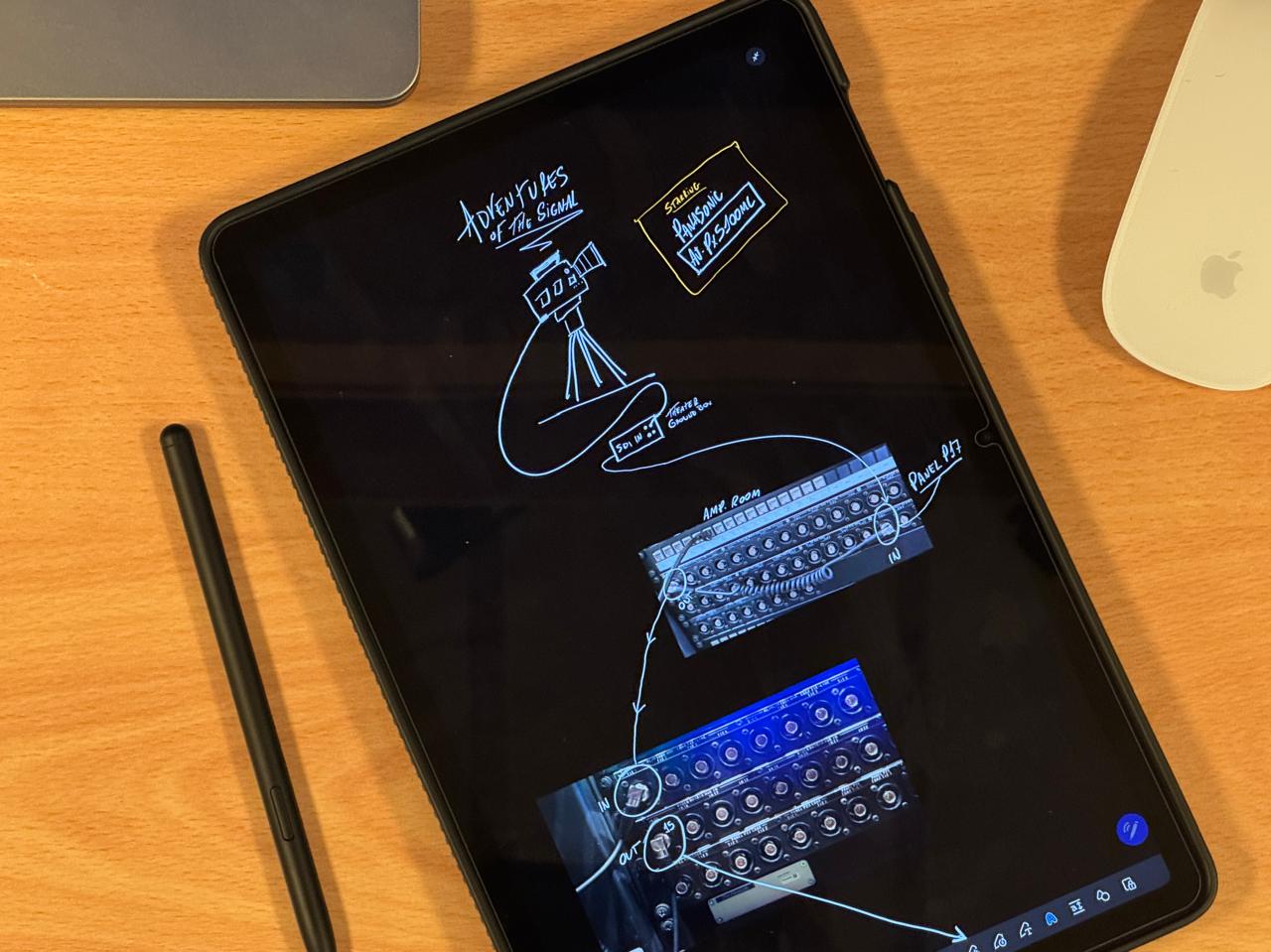 Hand-drawn signal flow diagrams and broadcast notes on a tablet